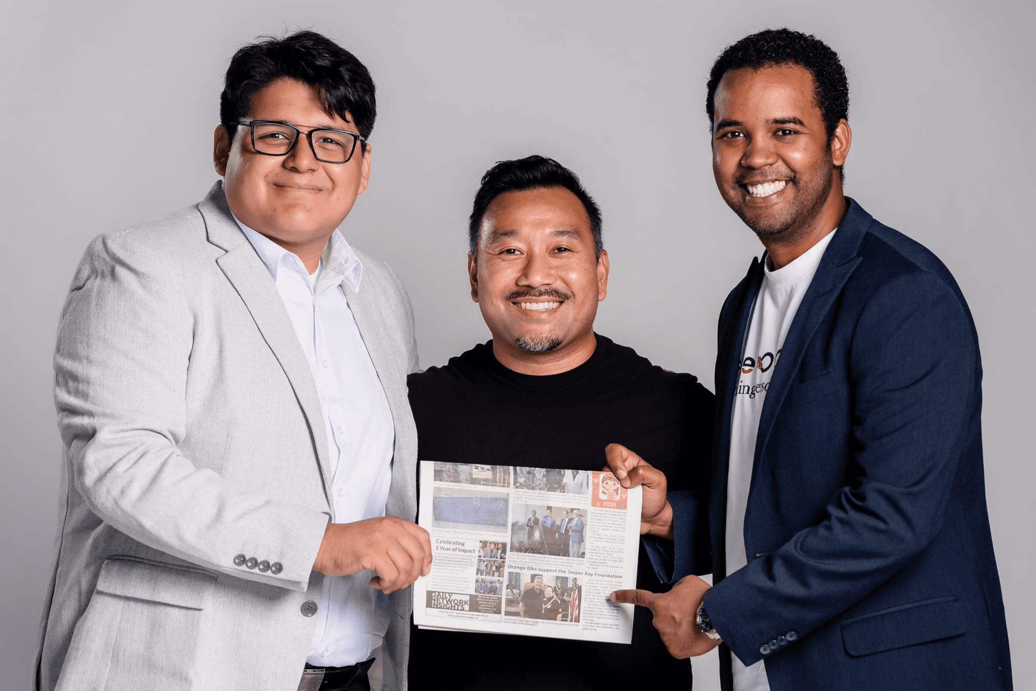 Team holding a newspaper featuring Daily Network Insights press release